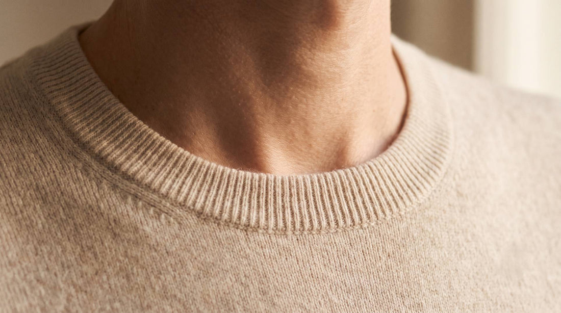 Fine-gauge cashmere crewneck collar resting against skin at the neckline