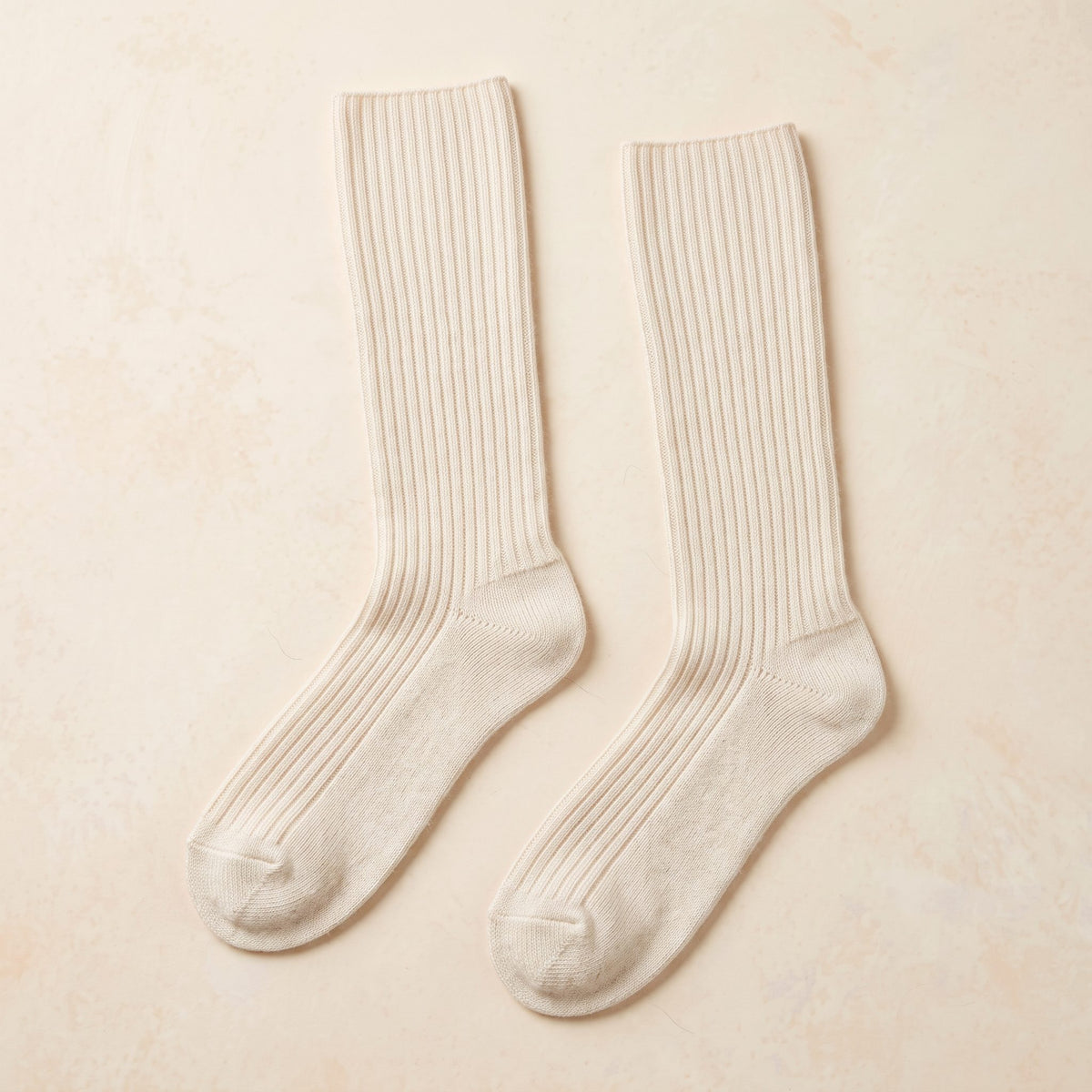 Off-White women's 100% cashmere knee-high socks - pair shown flat