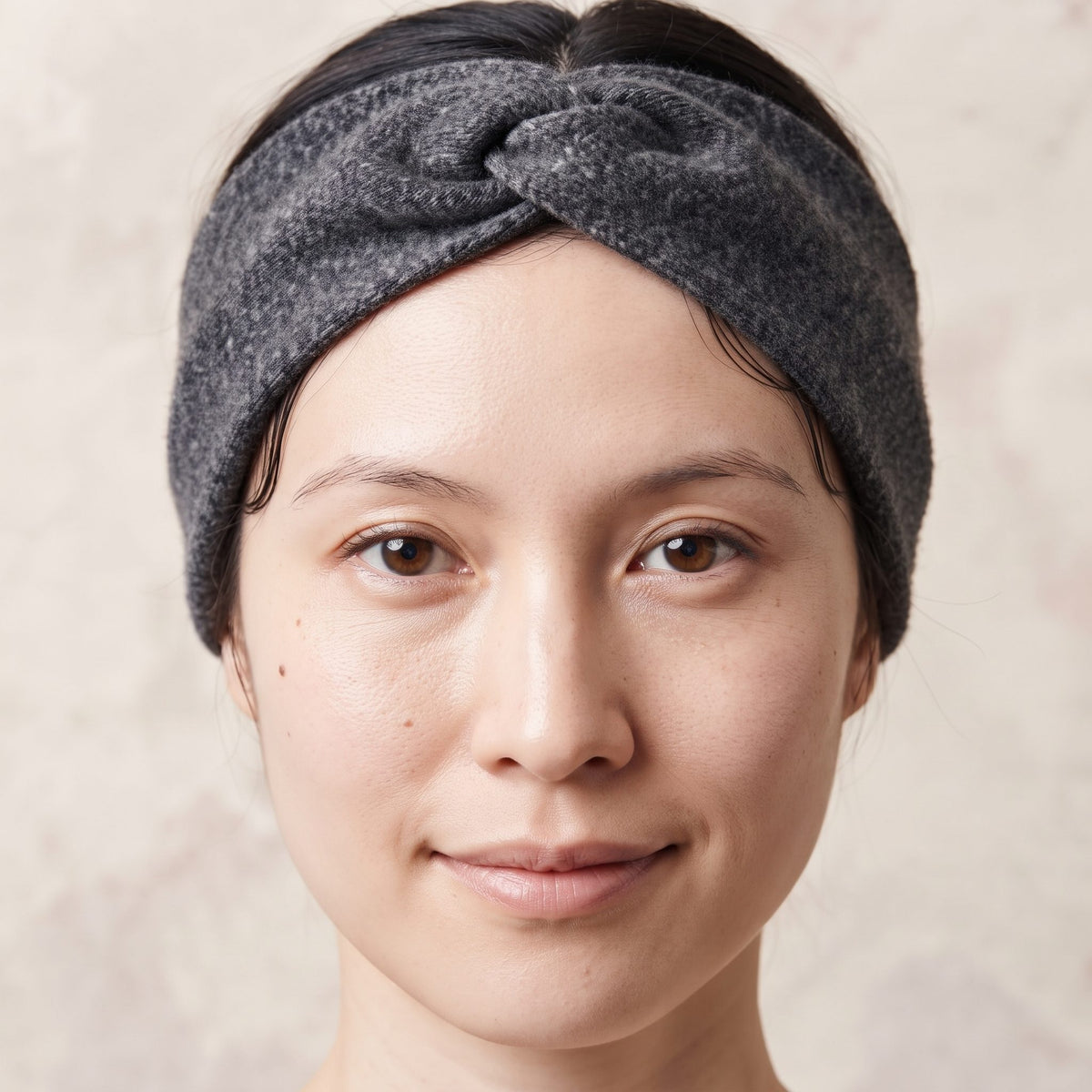 Undyed Gomba twisted-front cashmere headband in Dark Grey Melange, worn close