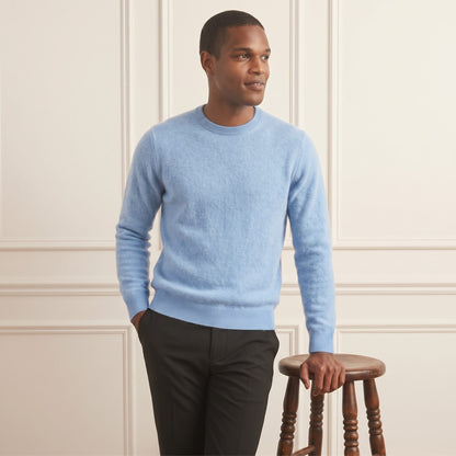 Sky blue men's 100% cashmere crewneck sweater - front view, standing beside stool