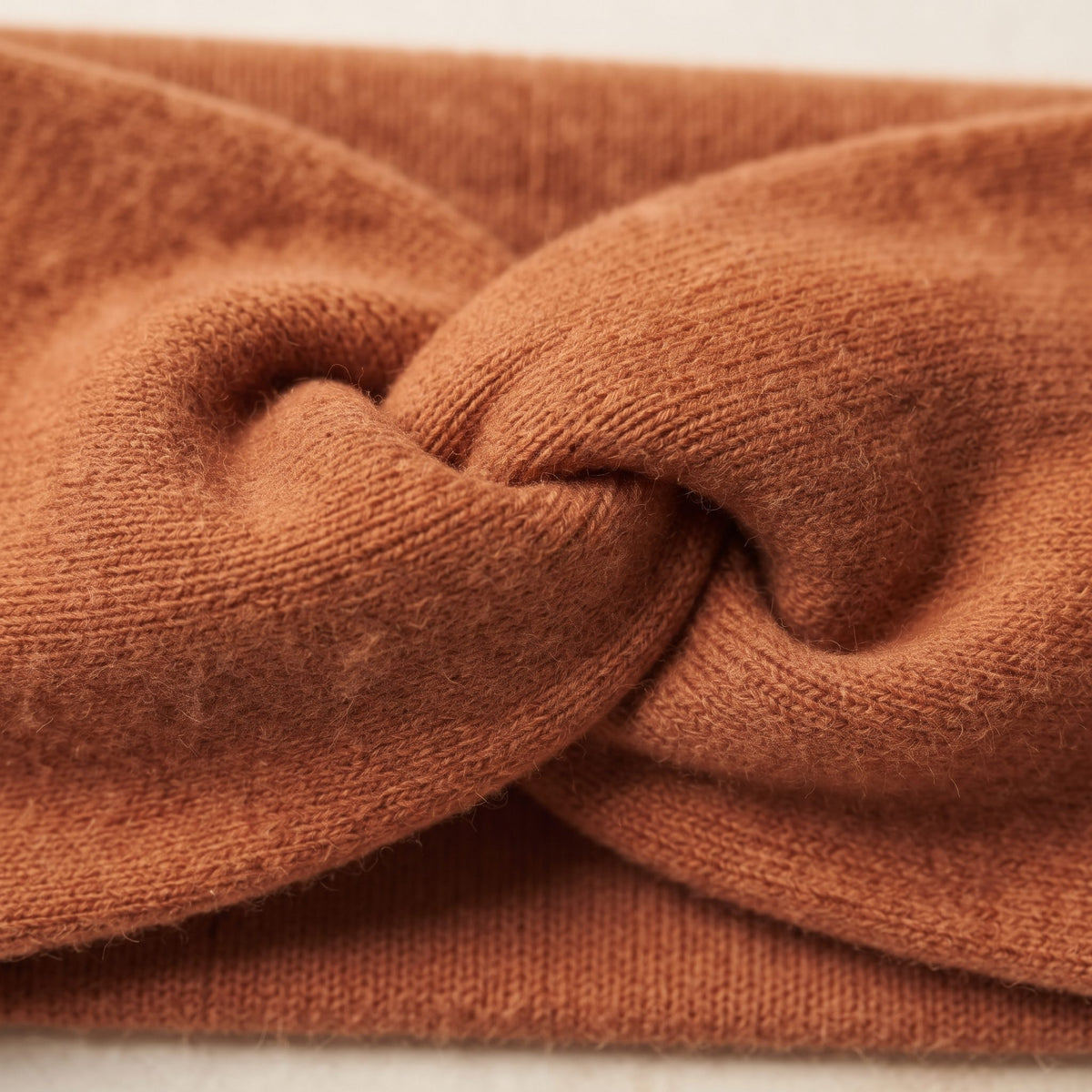 Gomba twisted-front cashmere headband in Amber, twist detail