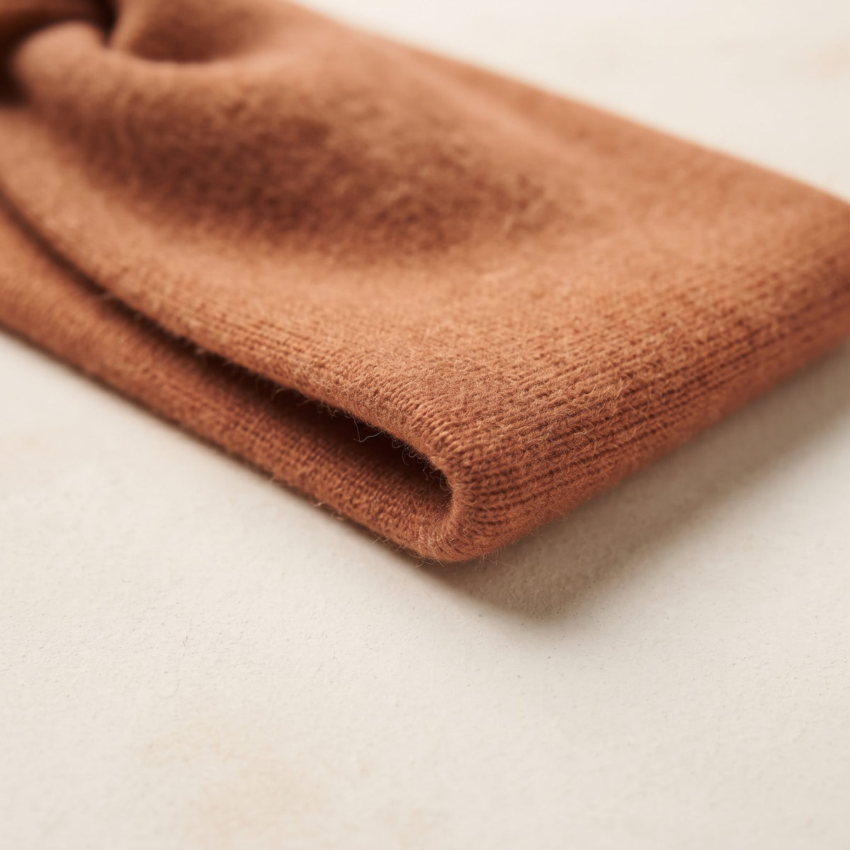 Gomba twisted-front cashmere headband in Amber, folded