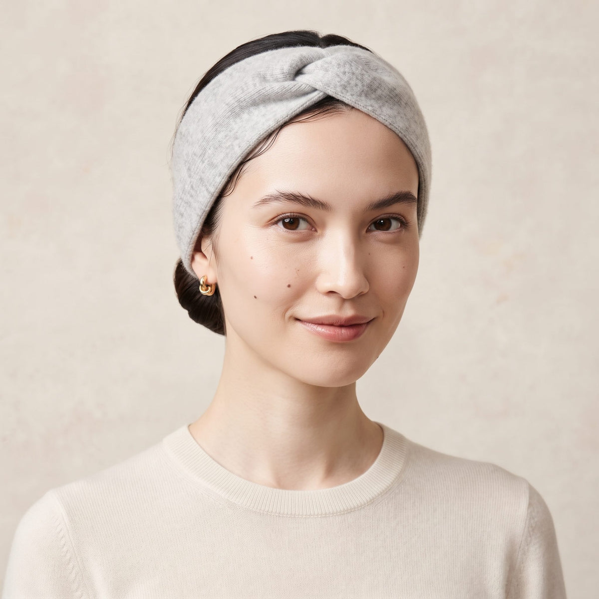Undyed Gomba twisted-front cashmere headband in Light Grey Melange, worn front