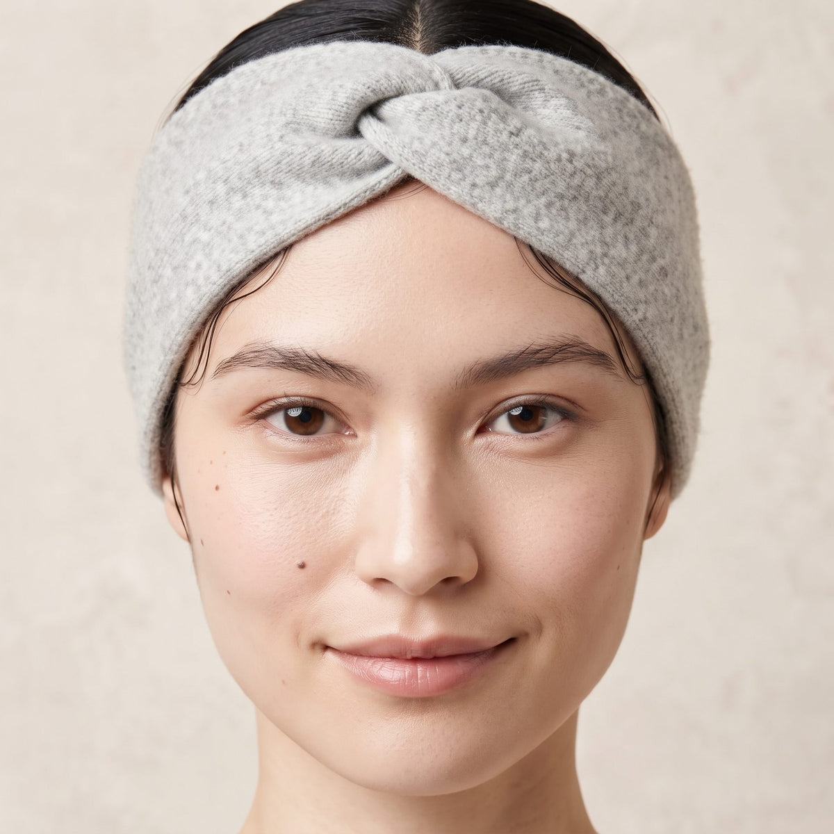 Undyed Gomba twisted-front cashmere headband in Light Grey Melange, worn close
