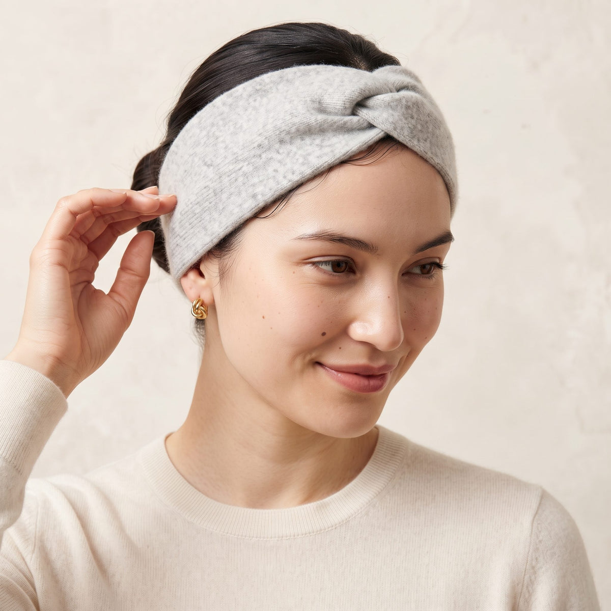 Undyed Gomba twisted-front cashmere headband in Light Grey Melange, worn, adjusting