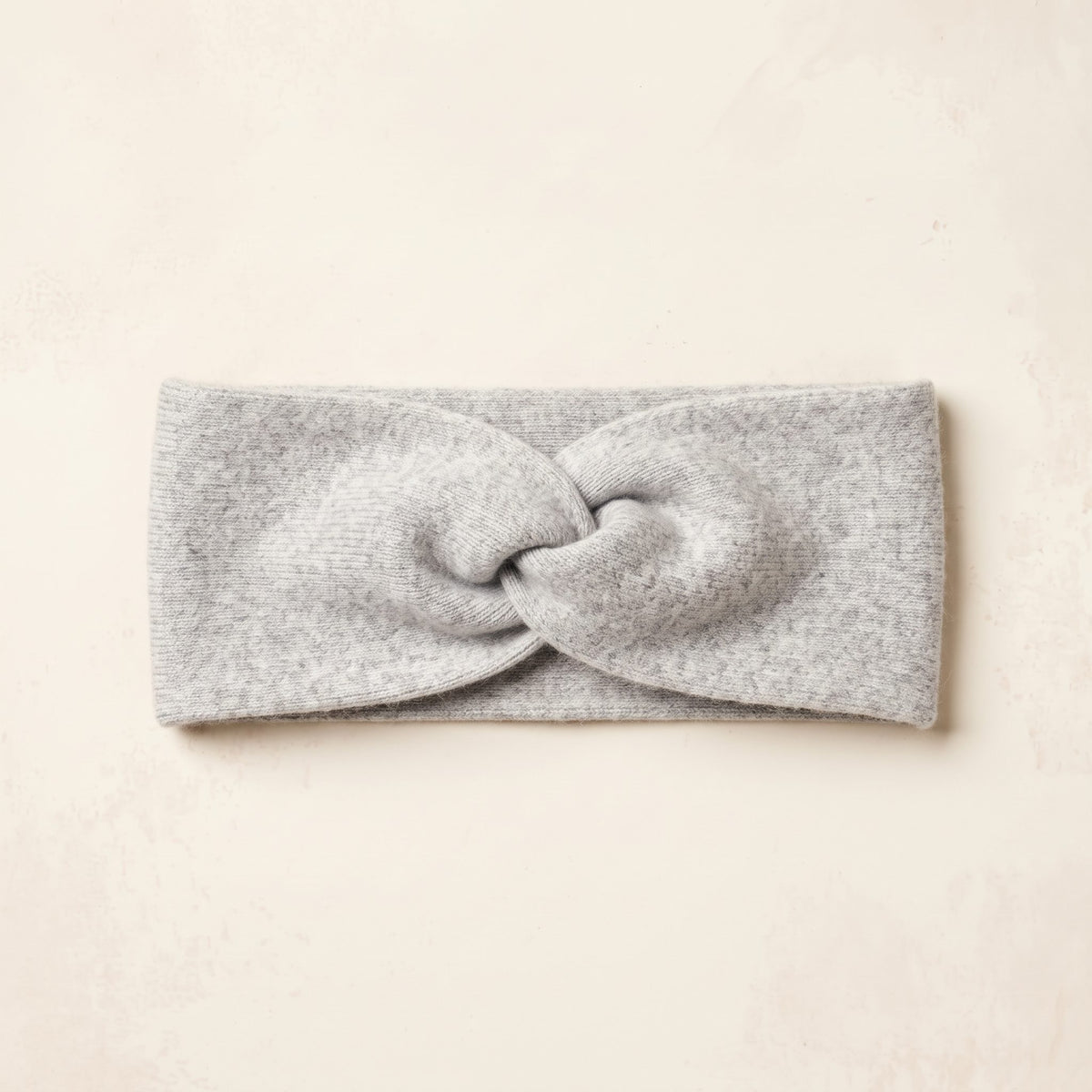 Undyed Gomba twisted-front cashmere headband in Light Grey Melange, flat front