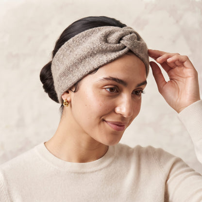 Undyed Gomba twisted-front cashmere headband in Toast Melange, worn, adjusting