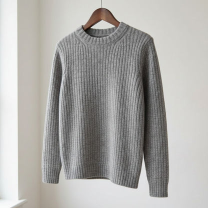 Gray ribbed sweater on a wooden hanger against a white background