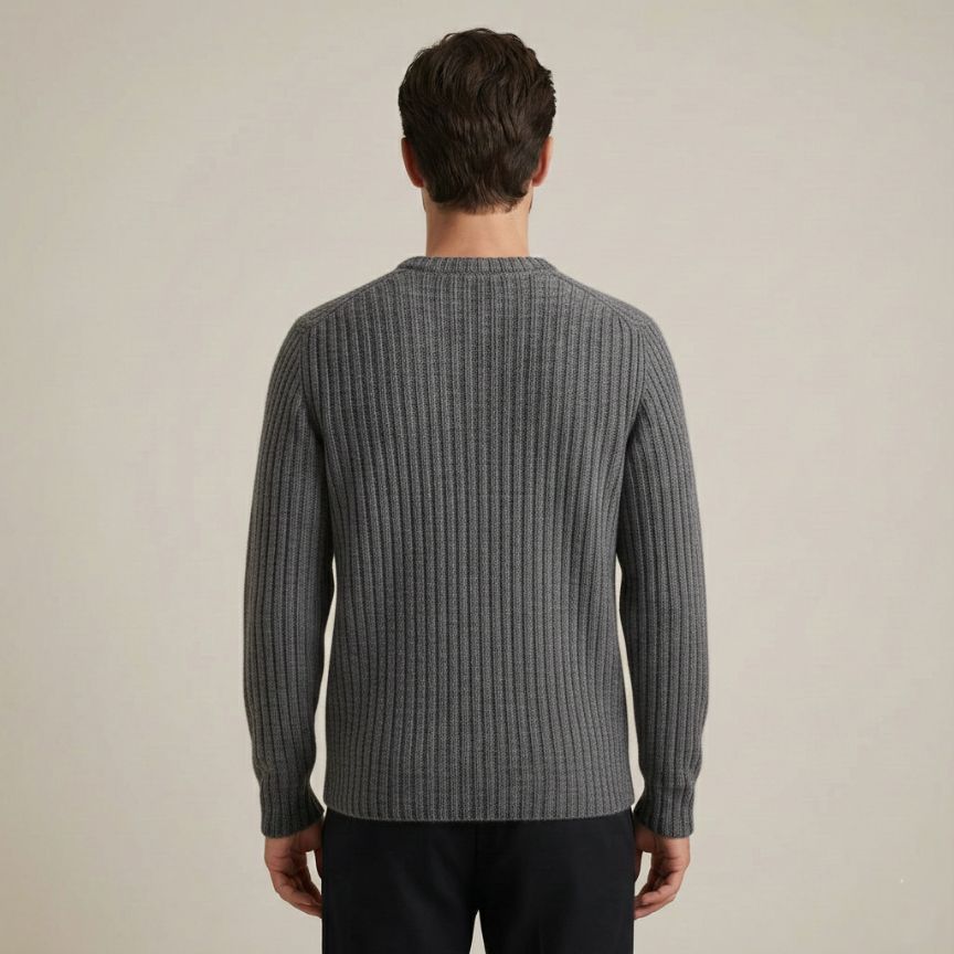 Man wearing a gray ribbed sweater against a beige background