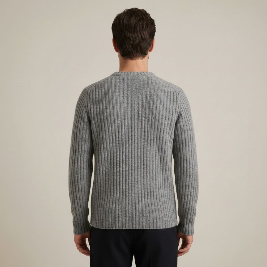 Man wearing a gray ribbed sweater against a beige background