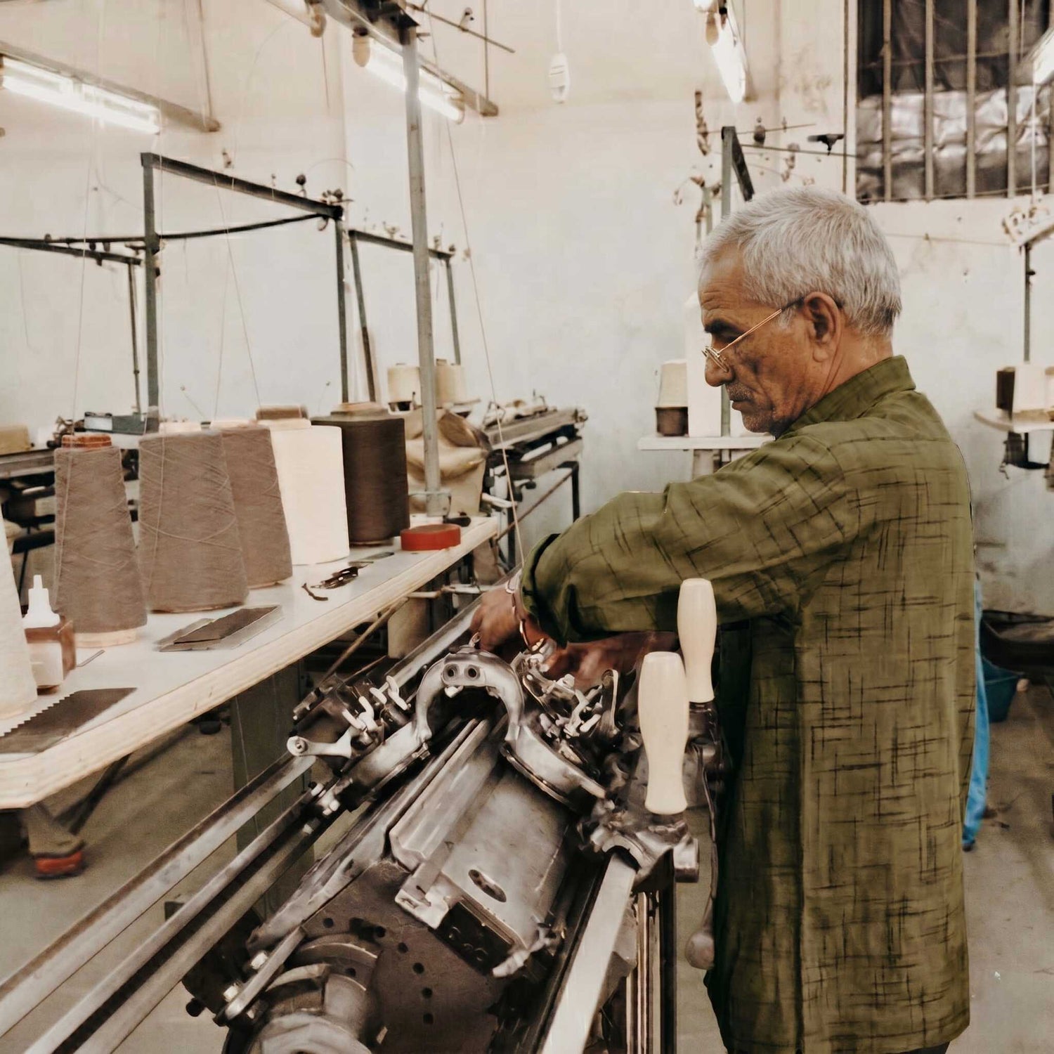 Man working on machinery in a factory setting
