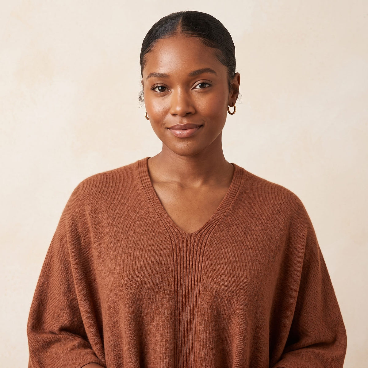 Women's V-neck cashmere poncho in Amber — worn by a model