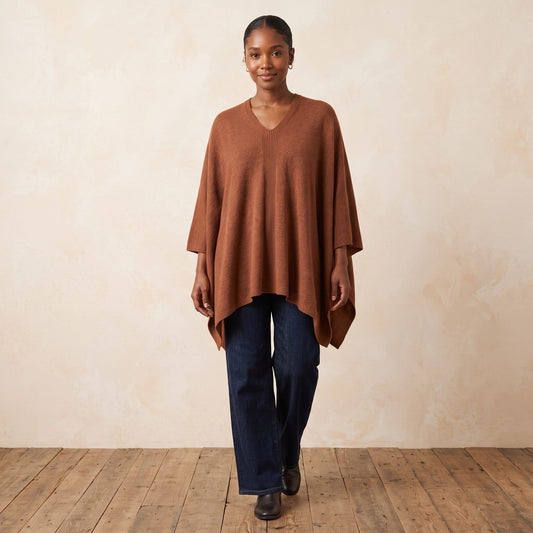 Women's V-neck cashmere poncho in Amber — worn by a model (2)