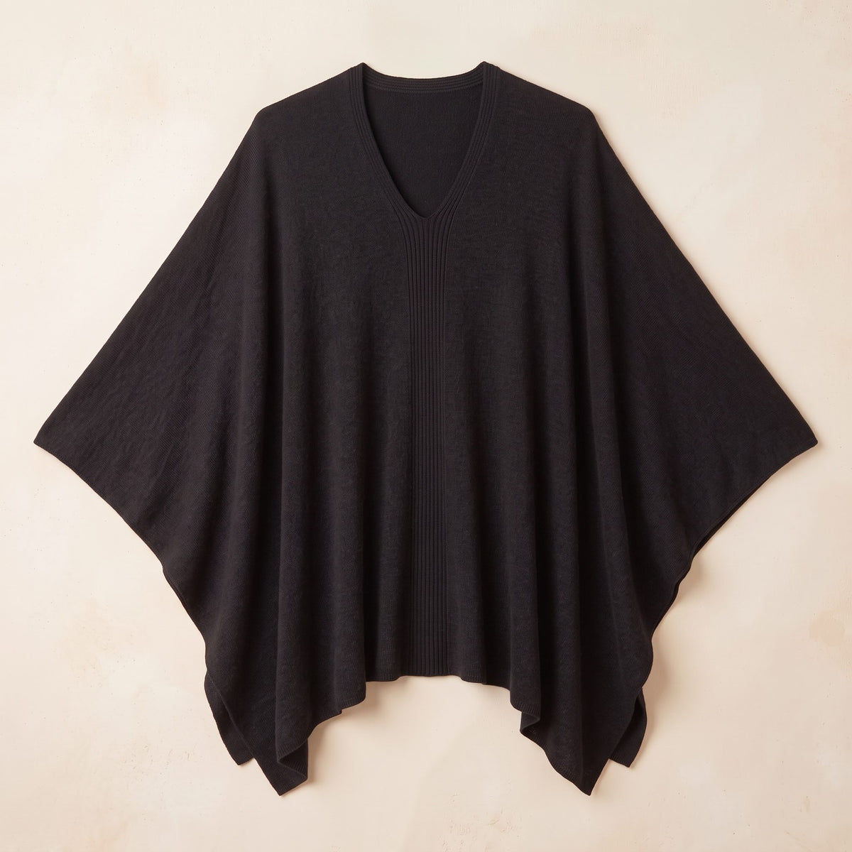 Women's V-neck cashmere poncho in Black — laid flat