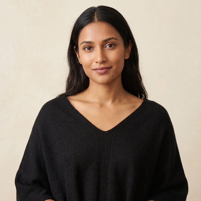 Women's V-neck cashmere poncho in Black — worn by a model