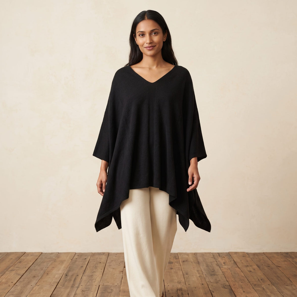 Women's V-neck cashmere poncho in Black — worn by a model (2)