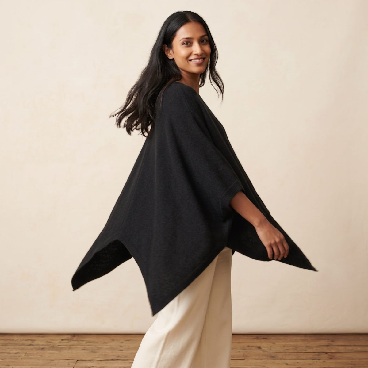 Women's V-neck cashmere poncho in Black — worn by a model (3)