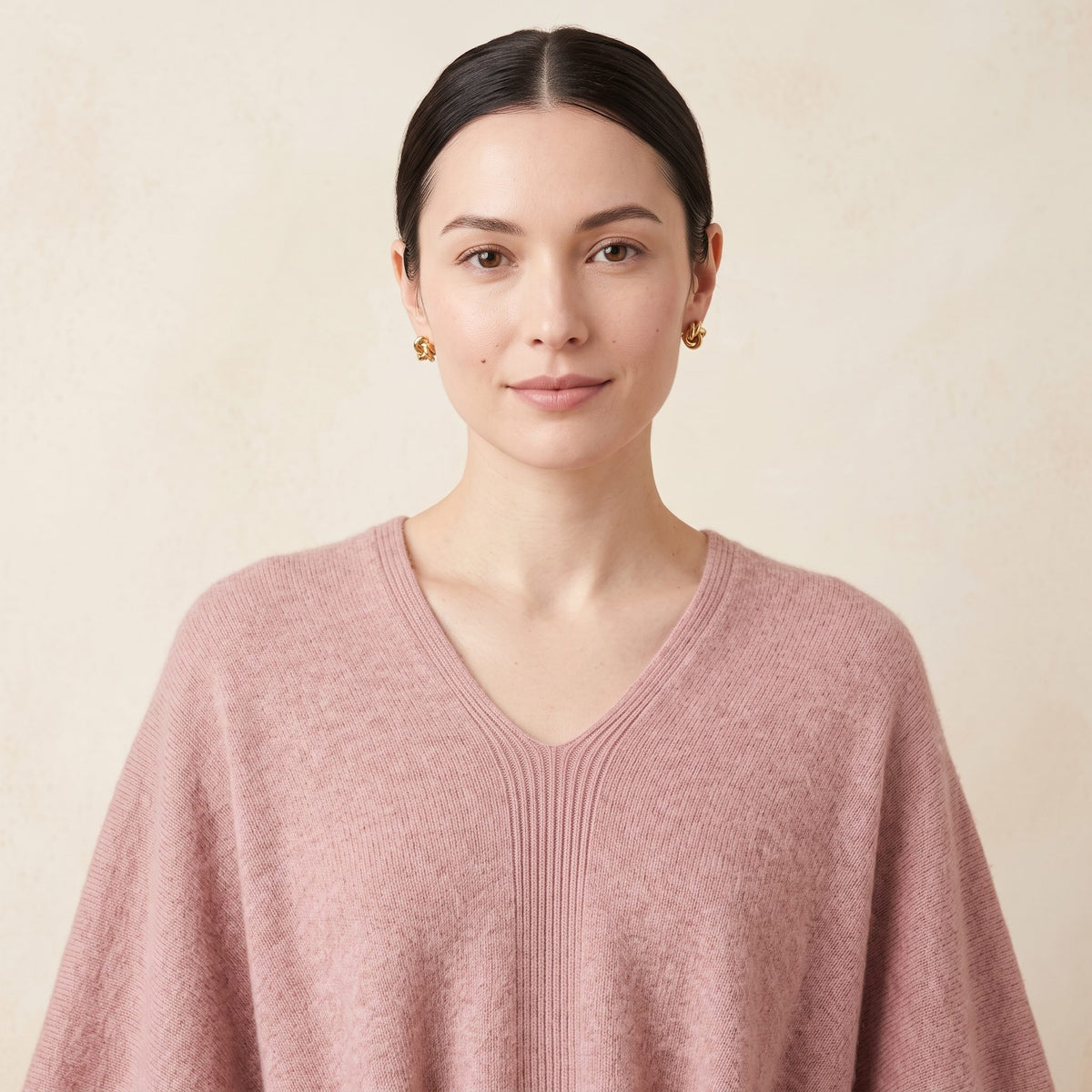 Women's V-neck cashmere poncho in Blush Pink — worn by a model