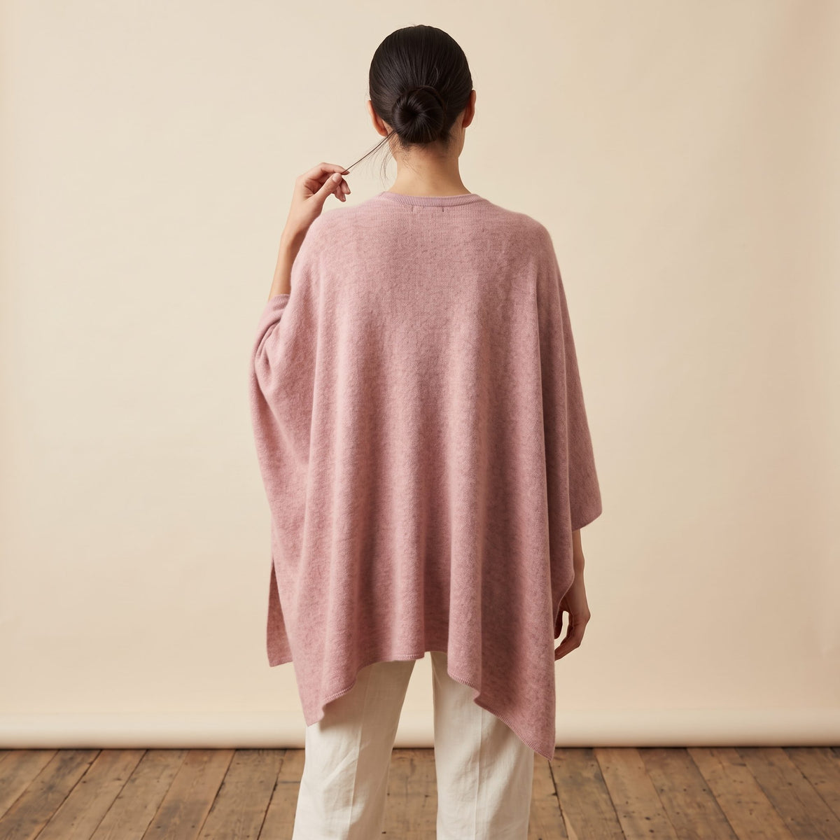Women's V-neck cashmere poncho in Blush Pink — worn by a model (4)