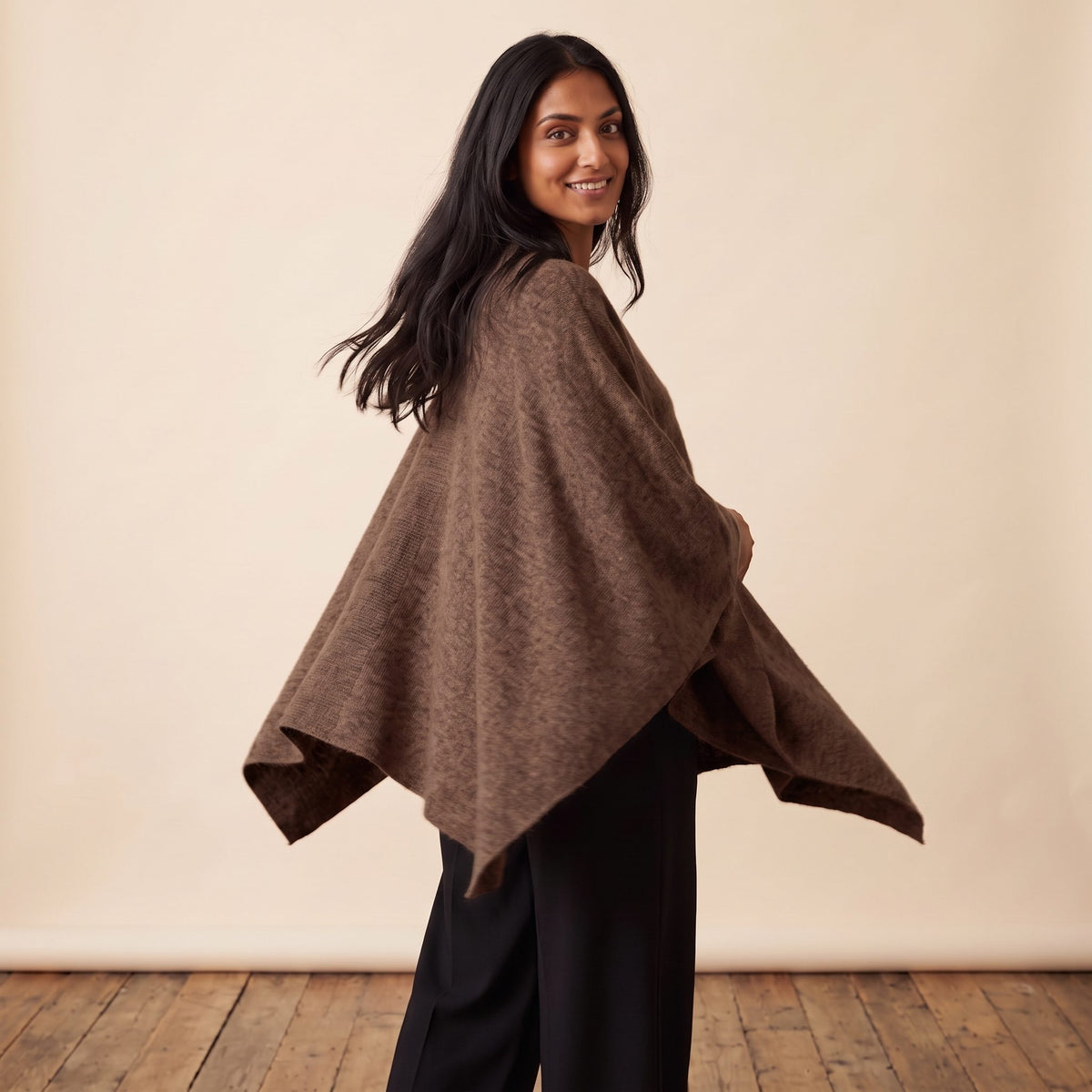 Women's V-neck cashmere poncho in Brown — worn by a model (3)