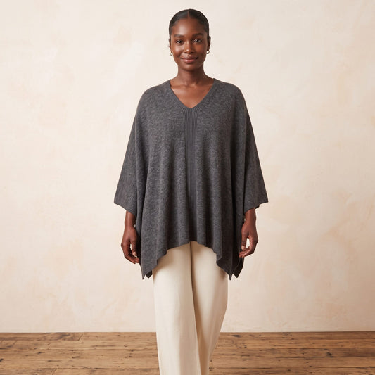 Women's undyed cashmere poncho in Dark Grey Melange — worn by a model (2)