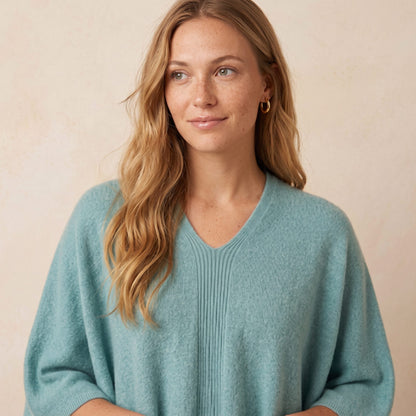 Women's V-neck cashmere poncho in Heathered Jade — worn by a model