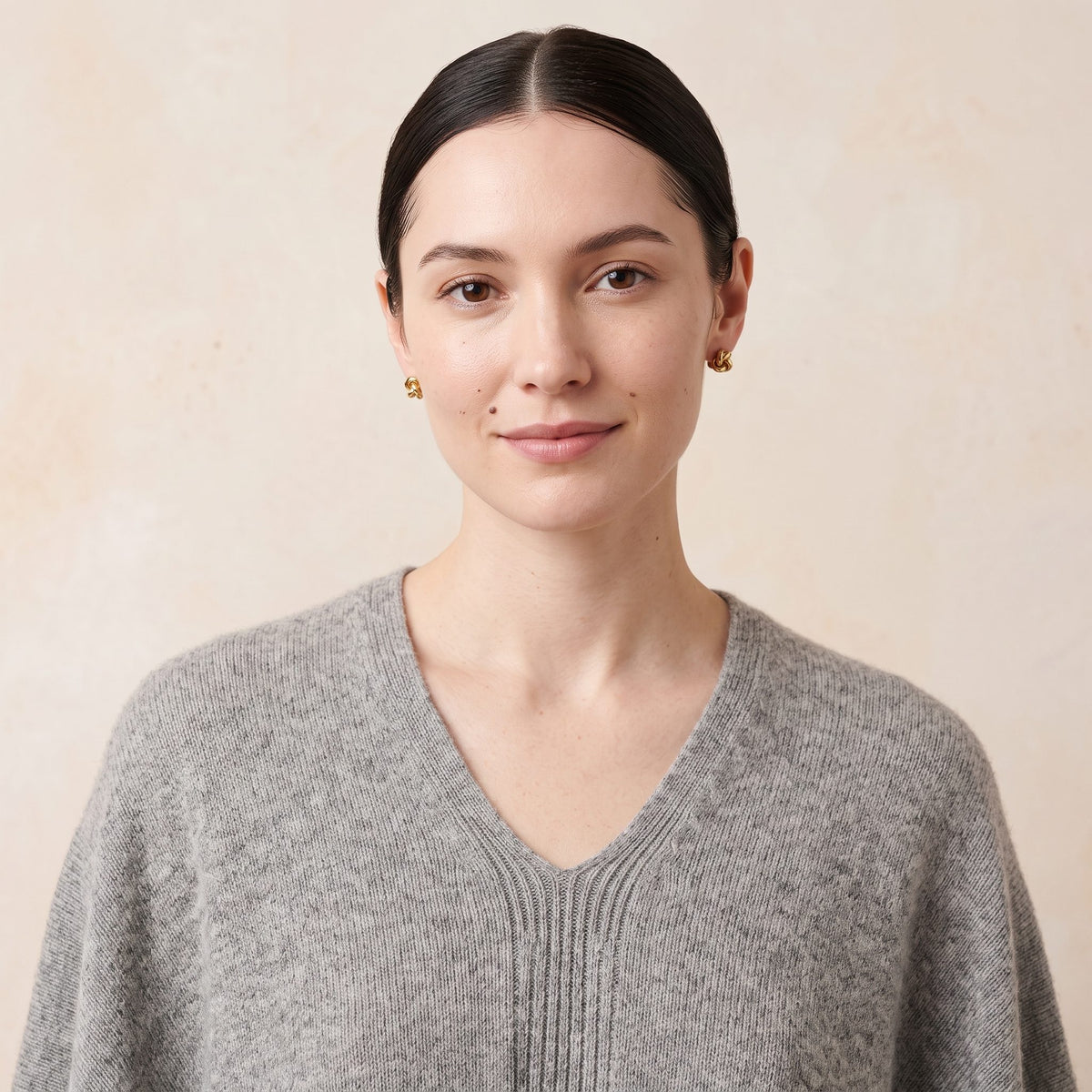 Women's undyed cashmere poncho in Light Grey Melange — worn by a model (2)