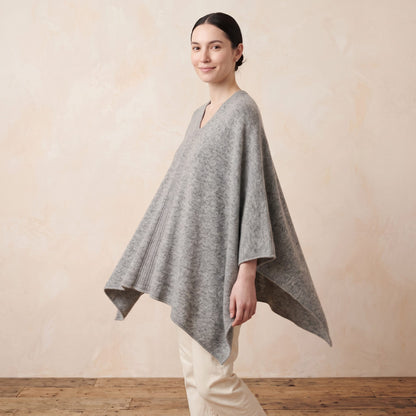 Women's undyed cashmere poncho in Light Grey Melange — worn by a model (4)