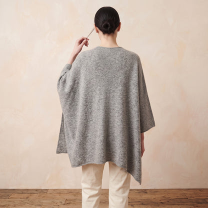 Women's undyed cashmere poncho in Light Grey Melange — worn by a model (5)