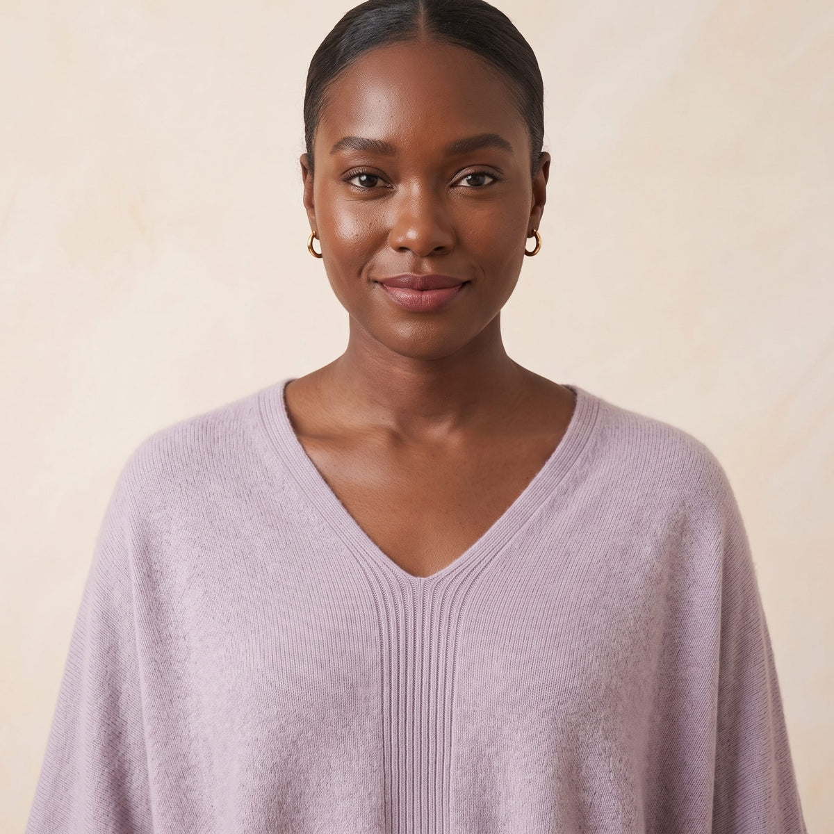 Women's V-neck cashmere poncho in Lilac — worn by a model
