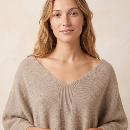 Women's undyed cashmere poncho in Oatmeal Melange — worn by a model