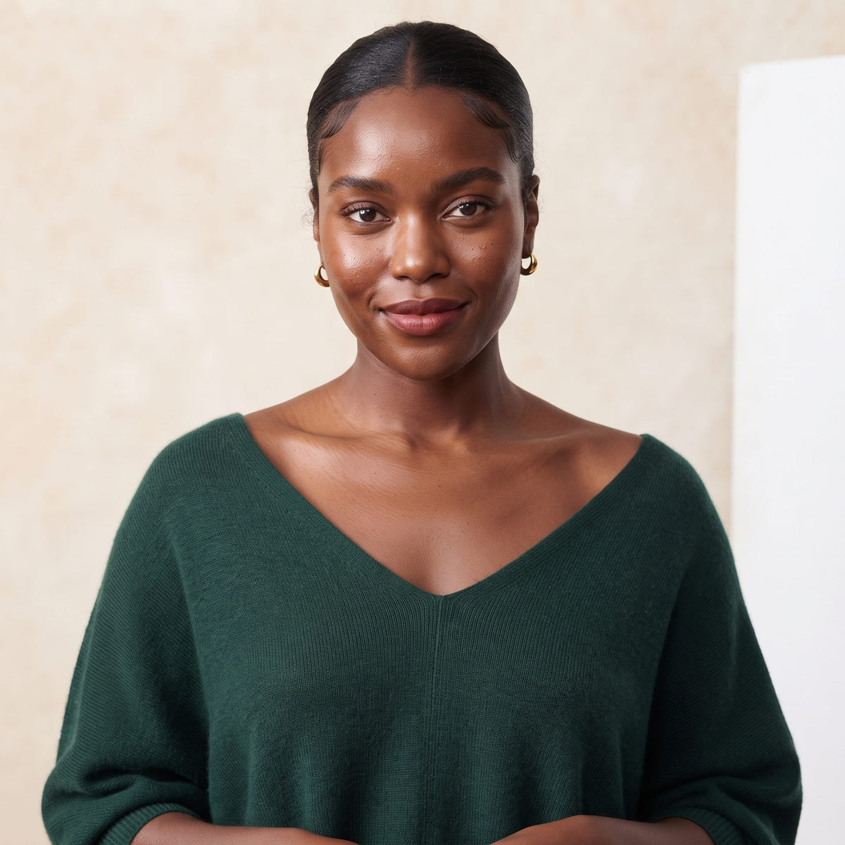 Women's V-neck cashmere poncho in Pine — worn by a model