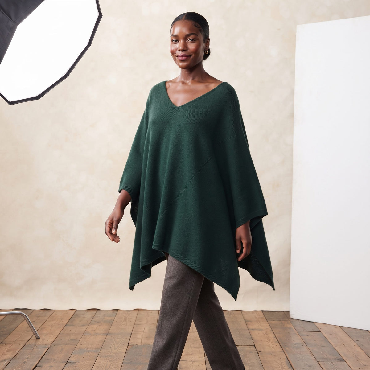 Women's V-neck cashmere poncho in Pine — worn by a model (2)