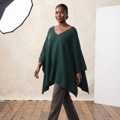 Women's V-neck cashmere poncho in Pine — worn by a model (2)