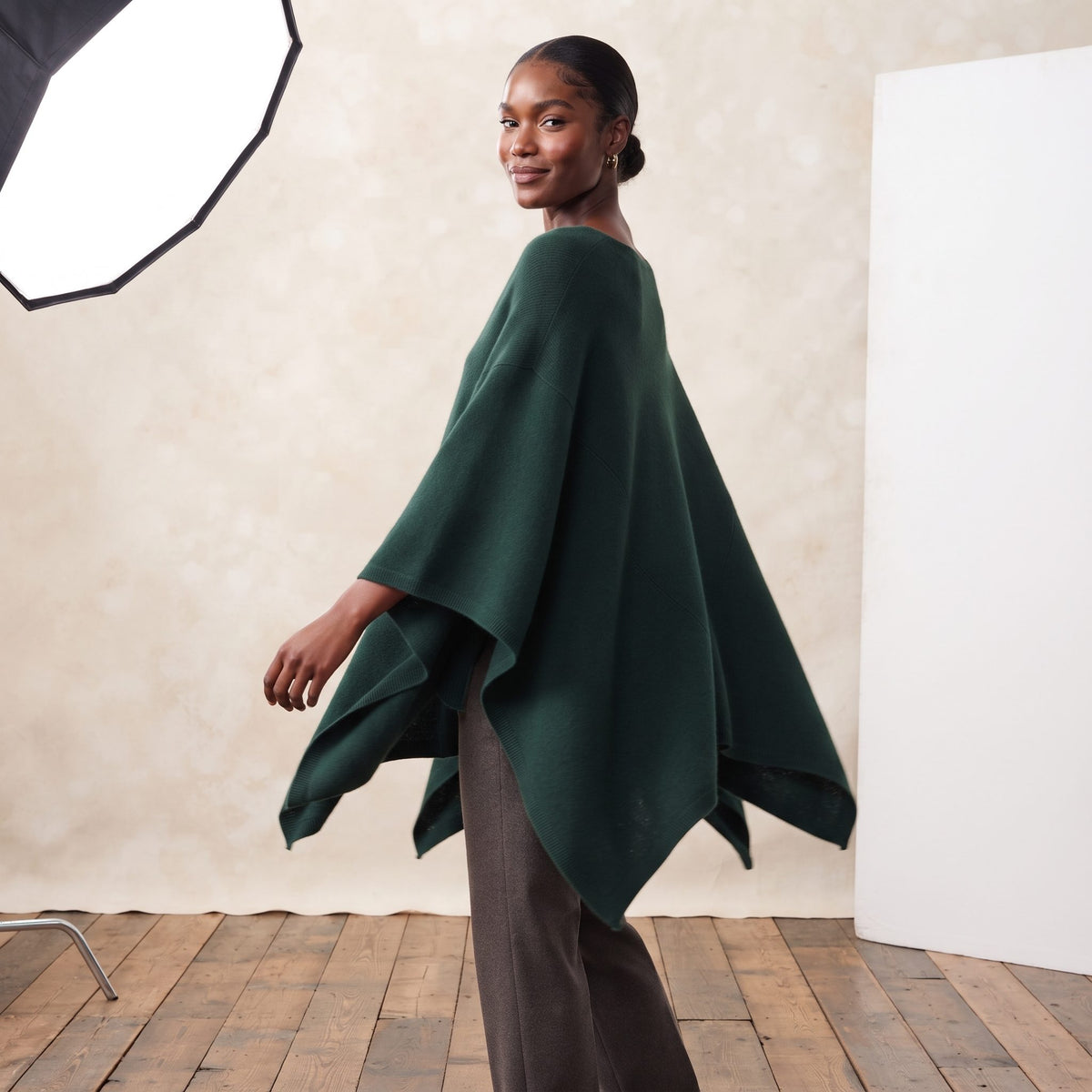 Women's V-neck cashmere poncho in Pine — worn by a model (3)