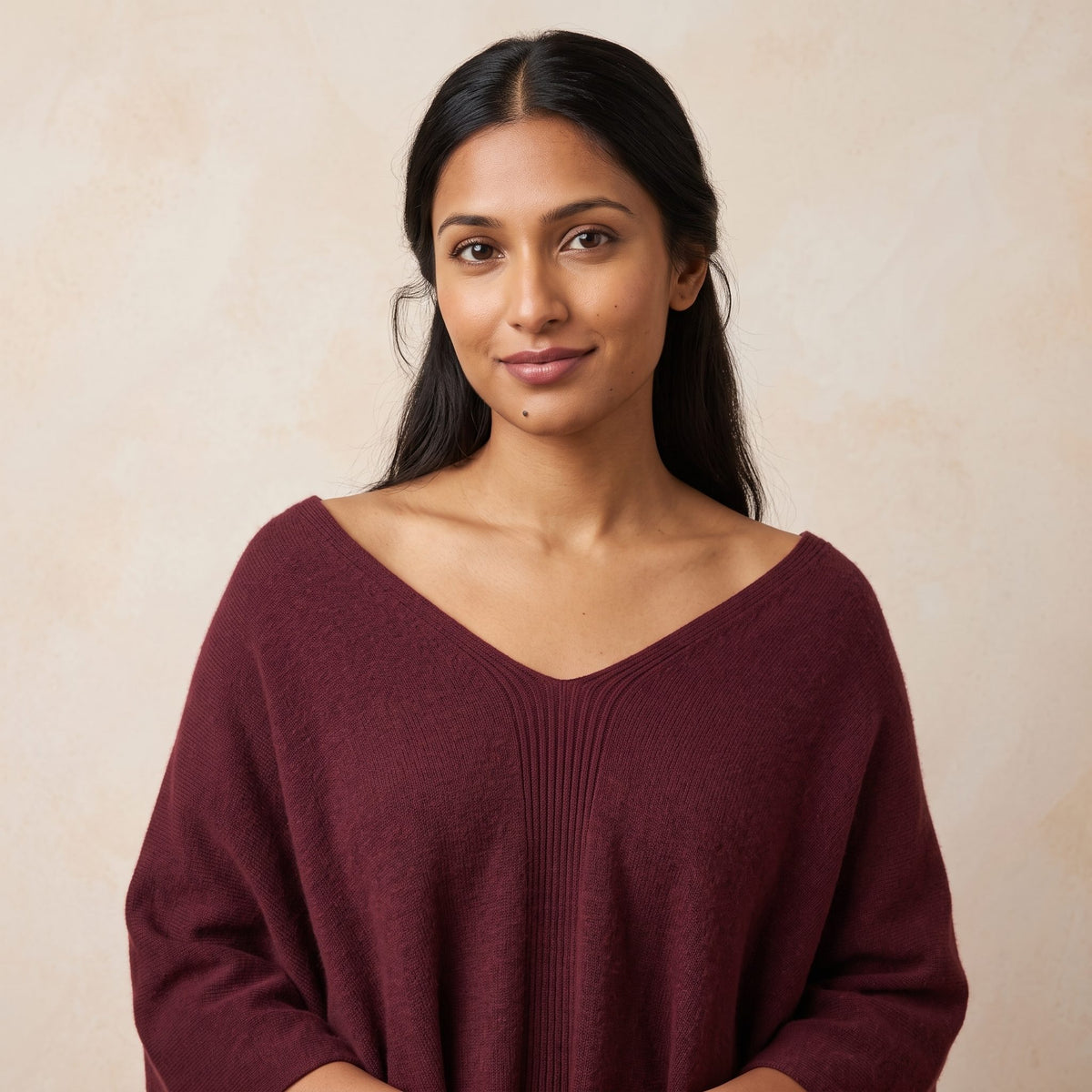 Women's V-neck cashmere poncho in Wine Red — worn by a model