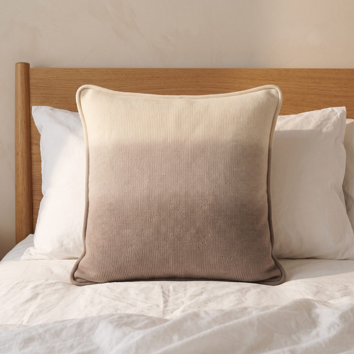 Toast Ombré 100% cashmere pillow cover, on a made bed